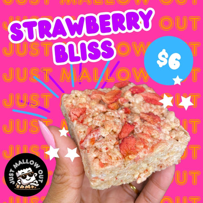 The image is an advertisement for a "STRAWBERRY BLISS" Rice Krispies treat, priced at $6. It's held by a hand against a pink background with the playful text "JUST MALLOW OUT" in orange and purple. The treat is dotted with red strawberry pieces, and the brand's logo featuring a cheerful marshmallow character is also displayed. Bright stars add a sparkling effect around the treat, highlighting its appeal.